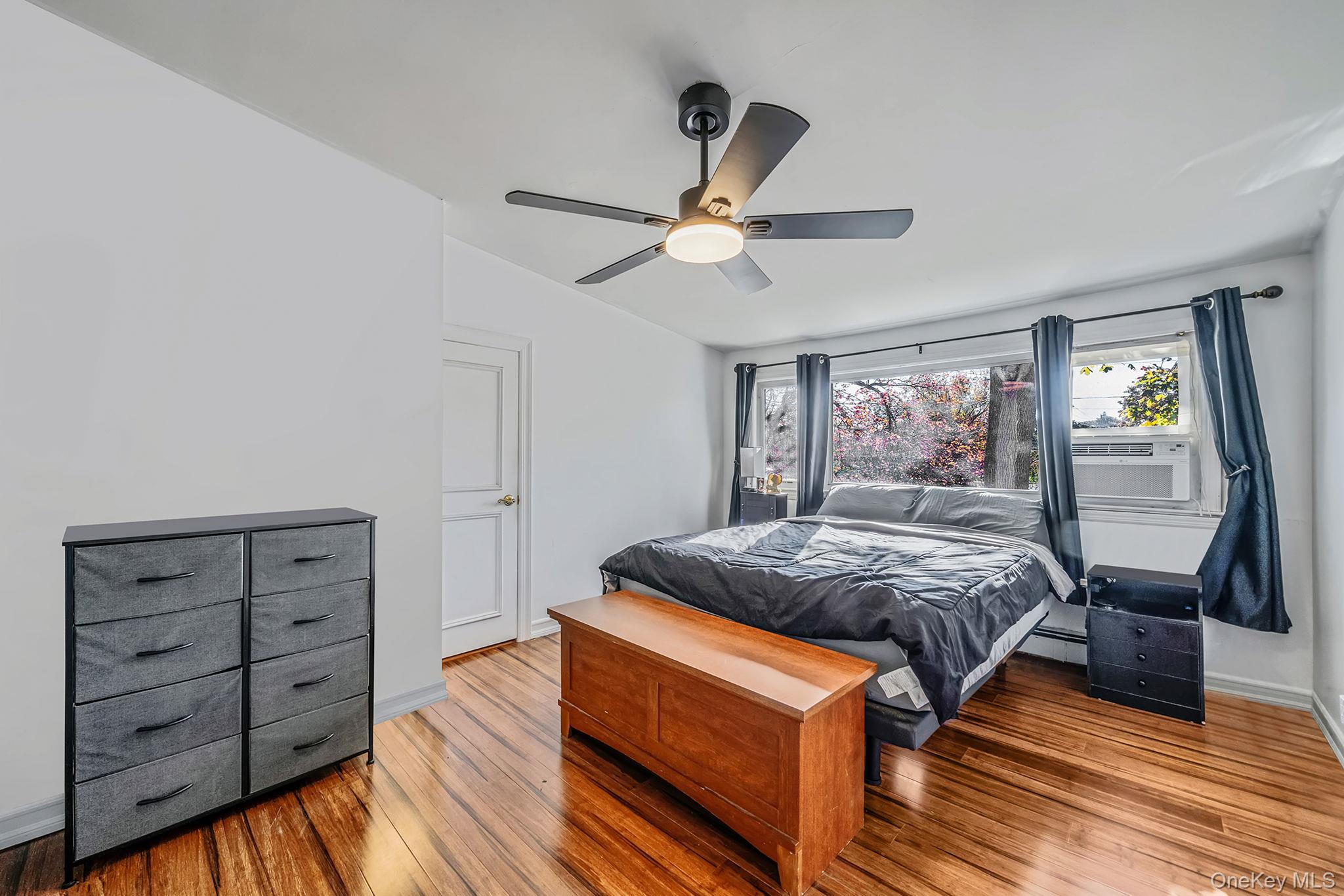267 Dogwood Road West Mastic Beach, NY 11951 - Photo 29 of 30 a bedroom with a bed and a chandelier