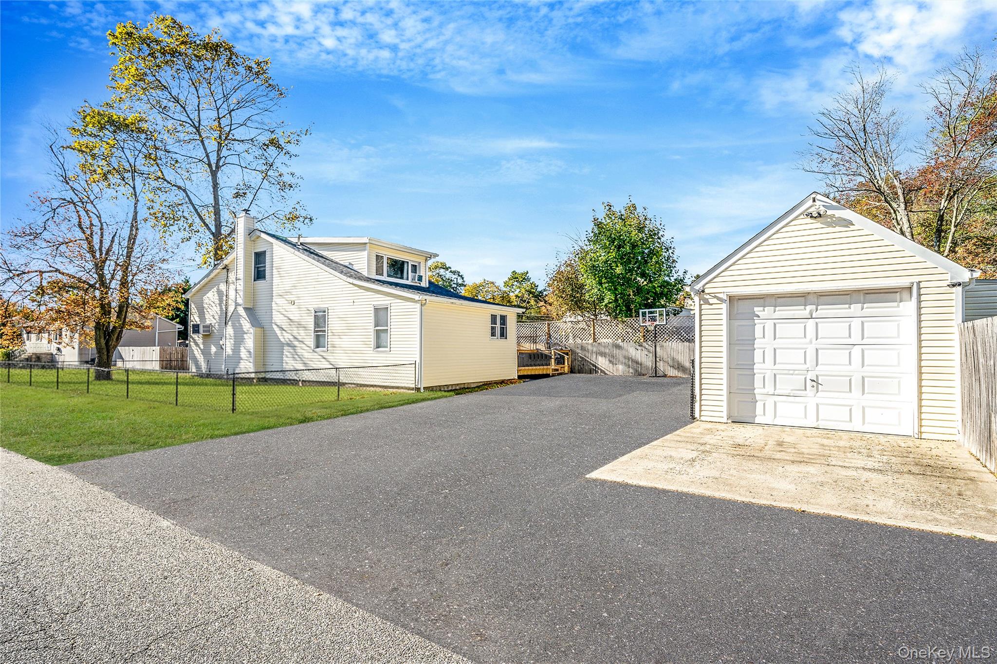 267 Dogwood Road West Mastic Beach, NY 11951 - Photo 3 of 30 a front view of a house with a yard and garage