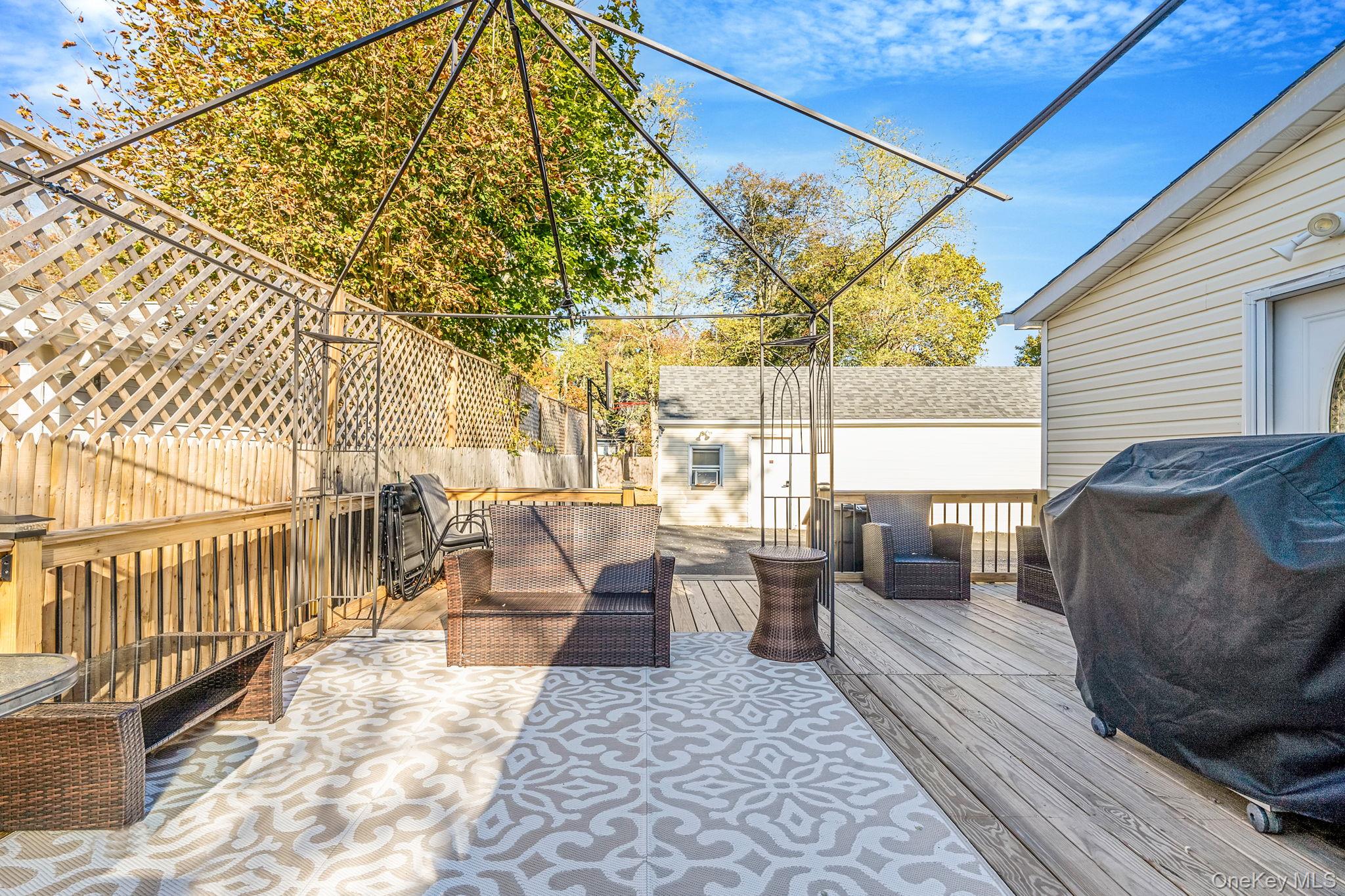 267 Dogwood Road West Mastic Beach, NY 11951 - Photo 8 of 30 a view of a patio with couches and table and chairs with wooden floor