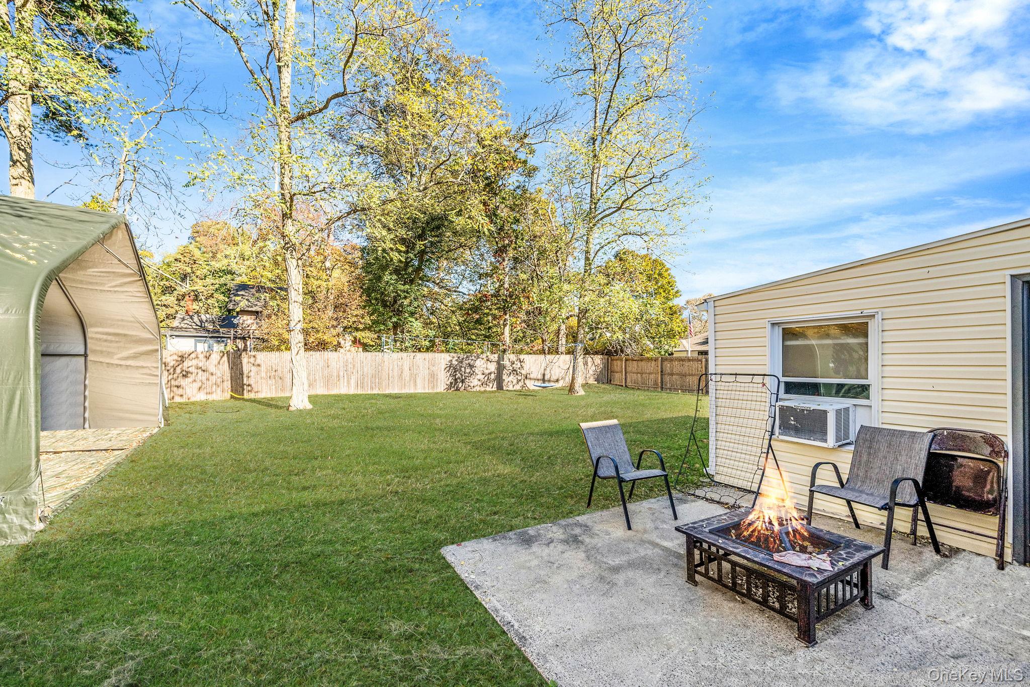 267 Dogwood Road West Mastic Beach, NY 11951 - Photo 10 of 30 a view of a backyard with plants and outdoor seating