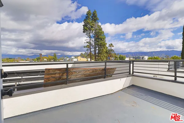 a view of a white house with a yard and garage