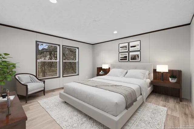 a spacious bedroom with a bed a couch and large window with outer view