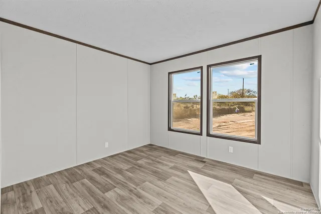 an empty room with windows and closet