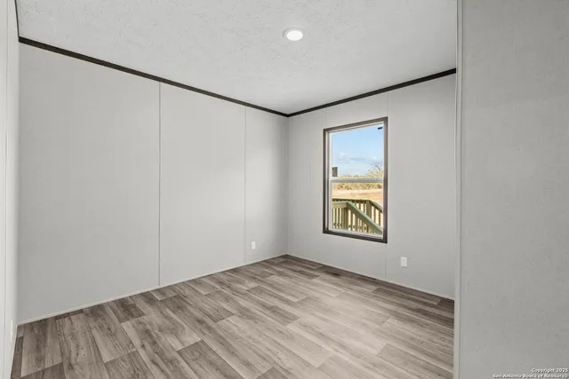 a balcony with wooden floor and fence