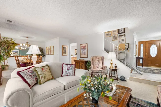 a view of a patio with table and chairs under an umbrella