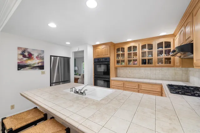a kitchen with granite countertop a sink and cabinets