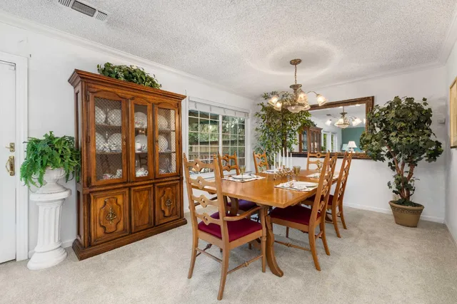 a view of a dining room with furniture and a kitchen