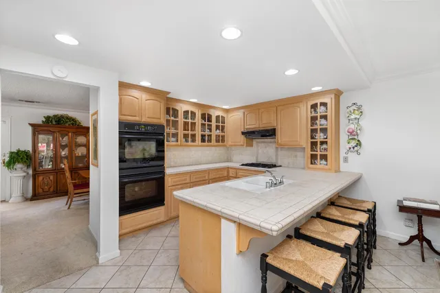 a large white kitchen with cabinets