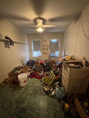 a gym room with lots of equipment and a chandelier