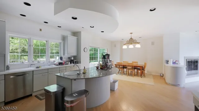 a kitchen with a dining table chairs sink and stove