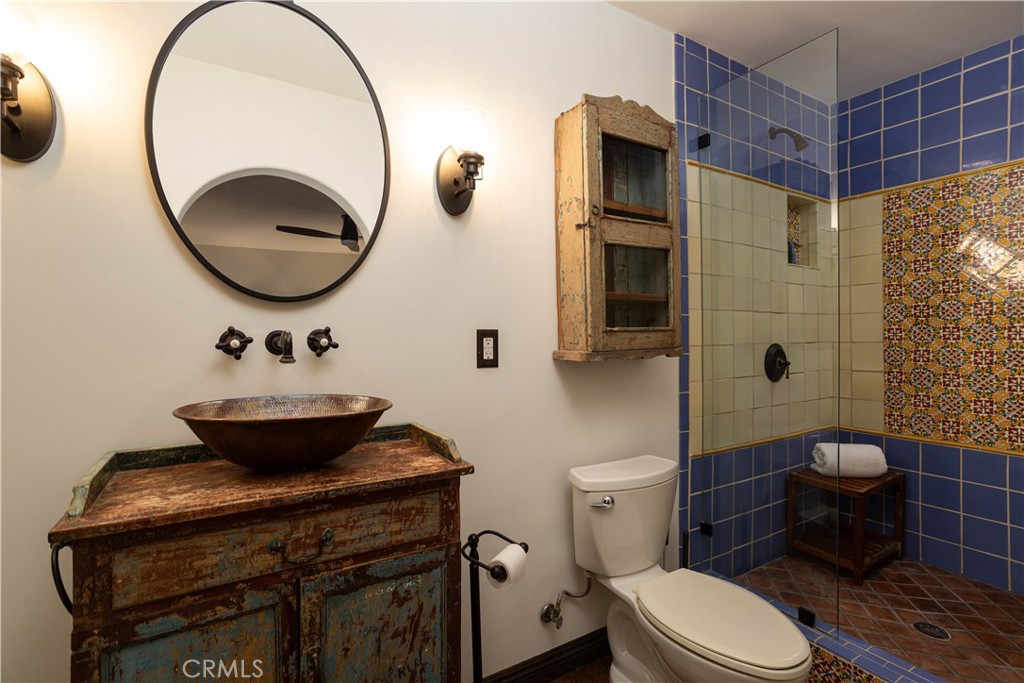 33791 Granada Drive Dana Point, CA 92629 - Photo 45 of 75 a bathroom with a toilet a sink and mirror