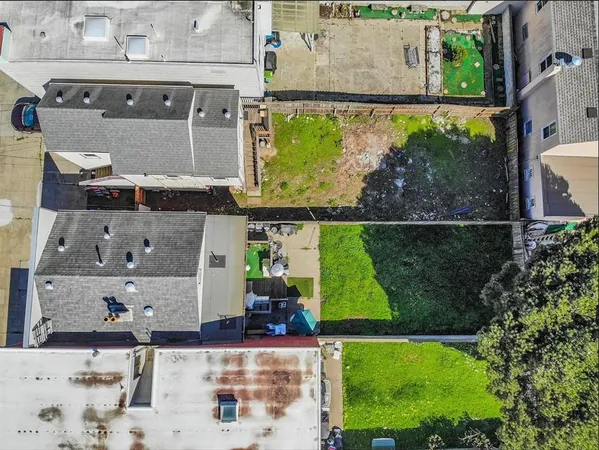 an aerial view of a house with a garden and a yard