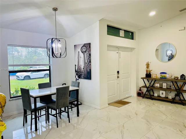 a view of a dining room and hall with furniture