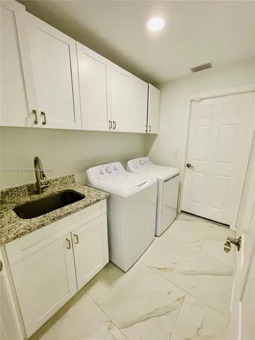 a kitchen with a sink stainless steel appliances and cabinets