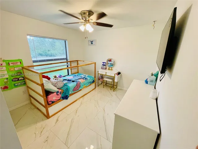 a bedroom with furniture and a window
