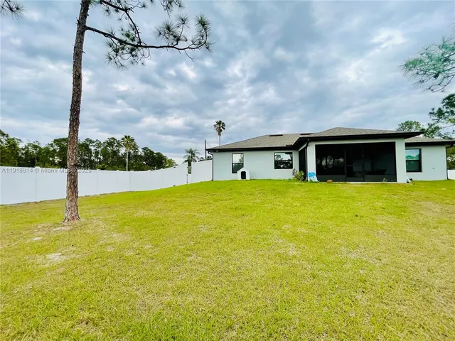 a view of a swimming pool with a yard