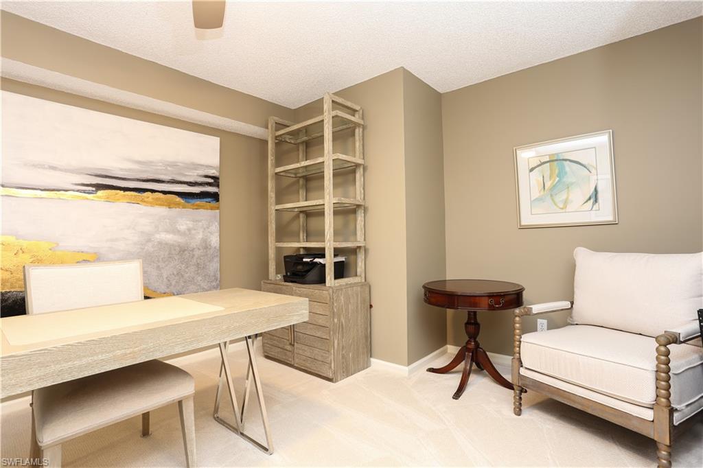5908 Cranbrook Way, Unit I103 Naples, FL 34112 - Photo 13 of 26 a living room with furniture and a window