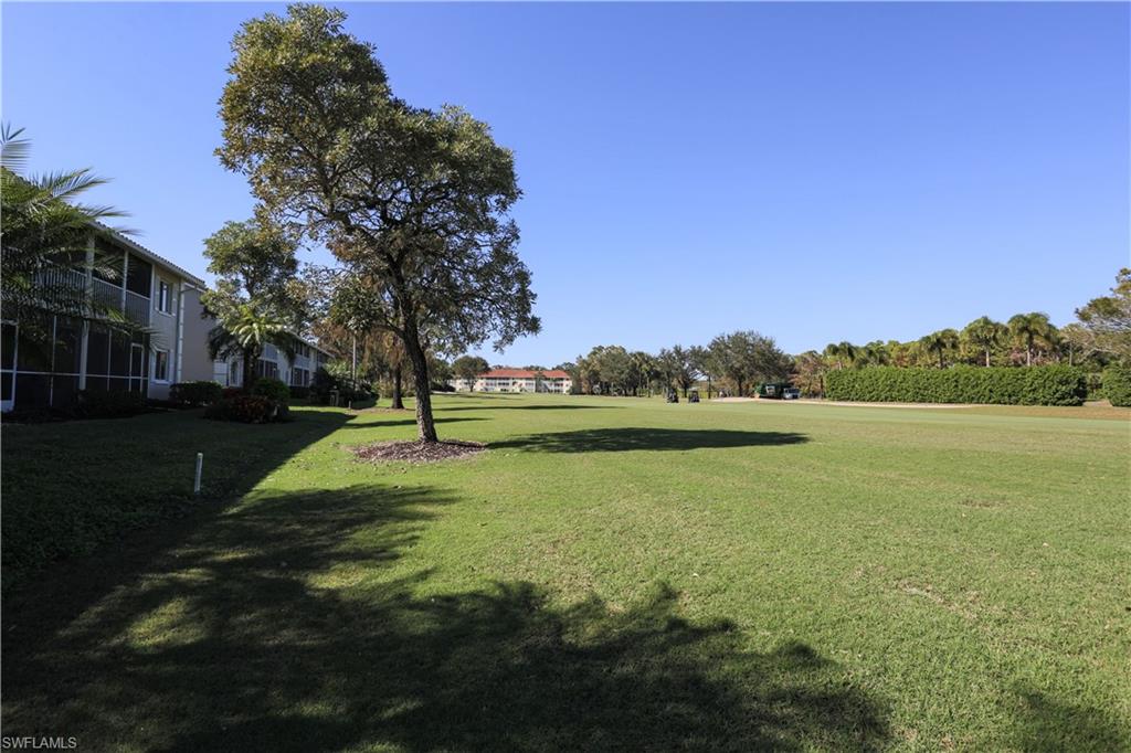 5908 Cranbrook Way, Unit I103 Naples, FL 34112 - Photo 20 of 26 a view of a lake with houses in the background