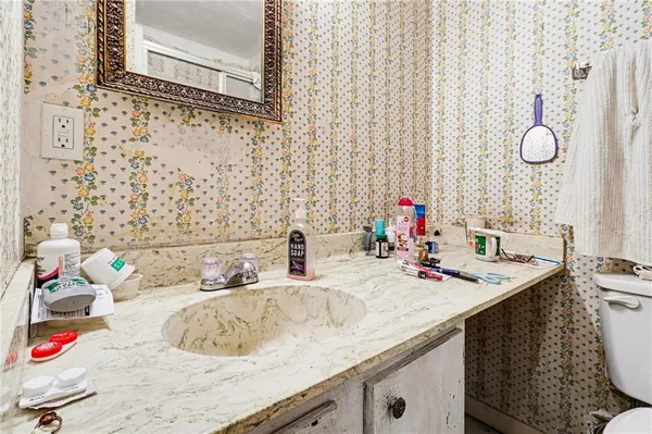 a bathroom with a sink vanity and mirror