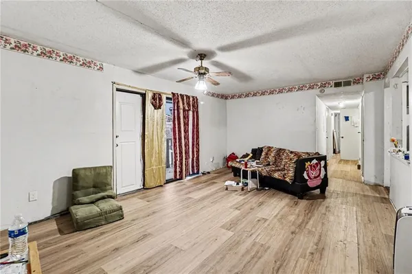 a living room with furniture and wooden floor