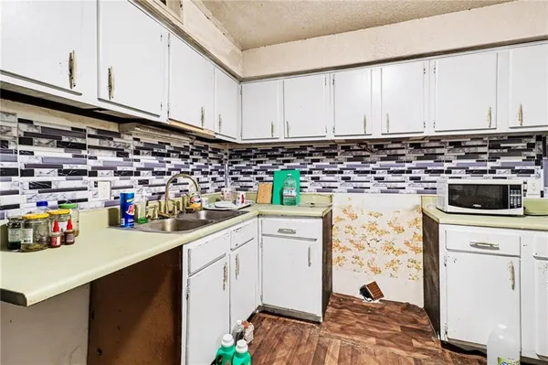 a kitchen with a sink and cabinets