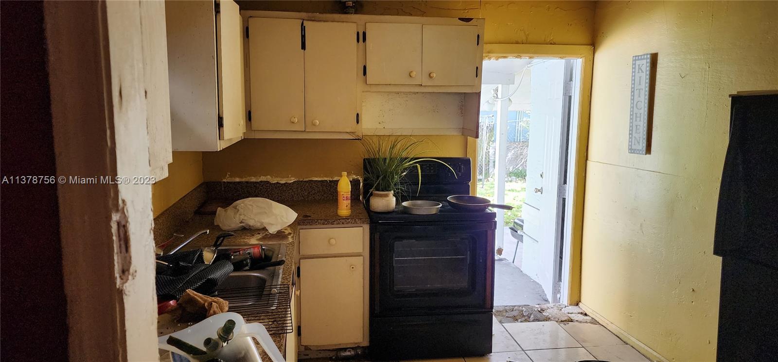 Gladeview Miami, FL 33147 - Photo 6 of 7 a kitchen with a refrigerator and cabinets