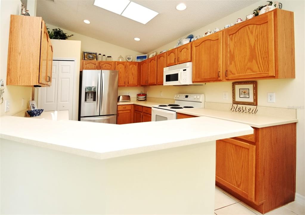 2591 Oneida Loop Kissimmee, FL 34747 - Photo 15 of 48 a kitchen with stainless steel appliances a refrigerator sink and microwave