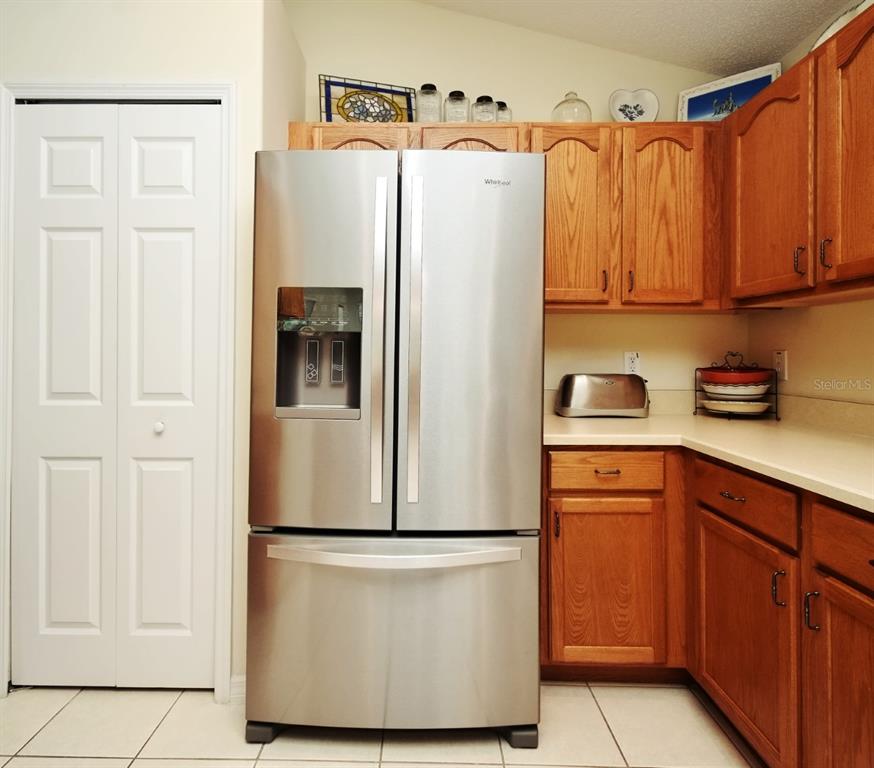 2591 Oneida Loop Kissimmee, FL 34747 - Photo 16 of 48 a white refrigerator freezer sitting in a kitchen