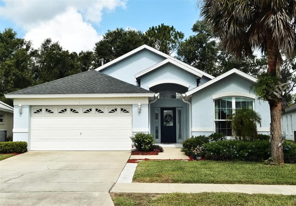2591 Oneida Loop Kissimmee, FL 34747 - Photo 2 of 48 a view of a house with garage and yard