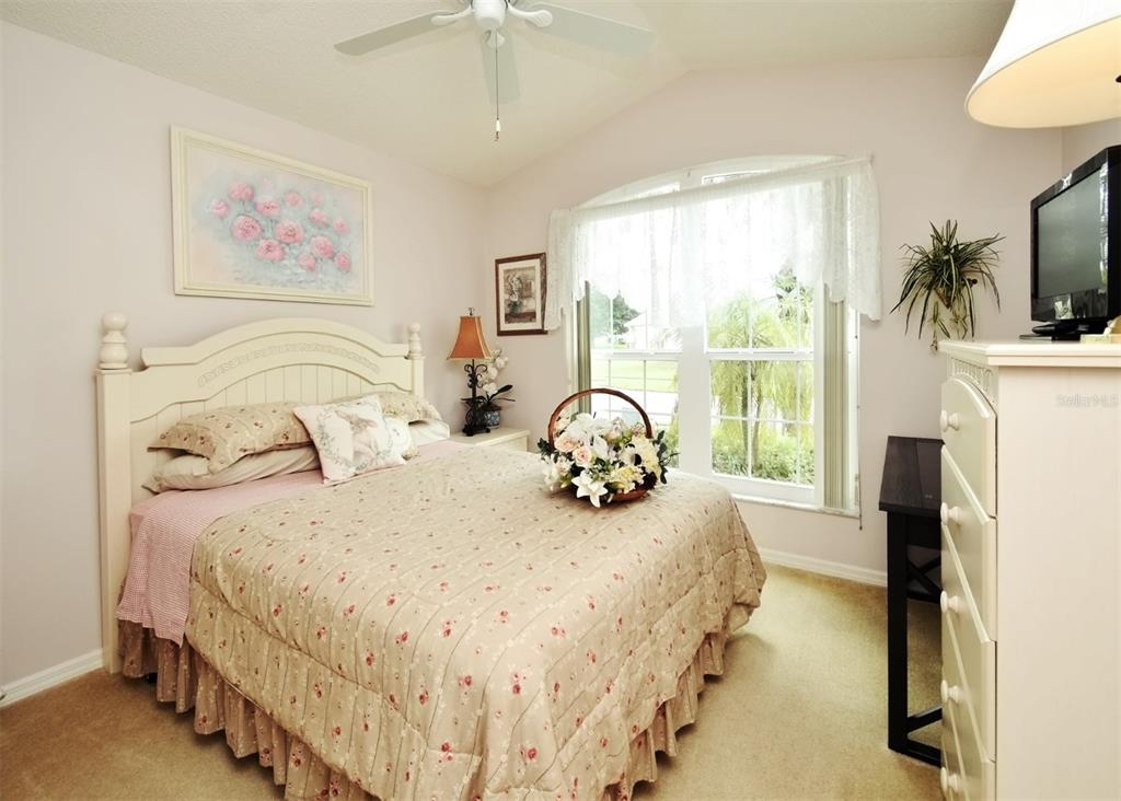 2591 Oneida Loop Kissimmee, FL 34747 - Photo 21 of 48 a bedroom with a bed and a flat screen tv