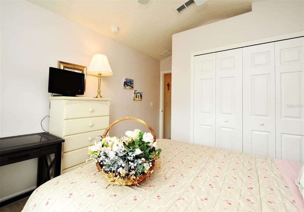 2591 Oneida Loop Kissimmee, FL 34747 - Photo 22 of 48 a living room with a couch and a flat screen tv