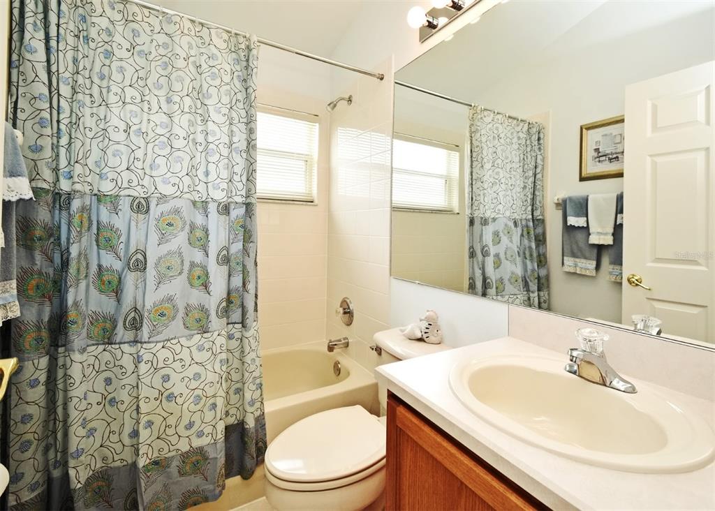 2591 Oneida Loop Kissimmee, FL 34747 - Photo 24 of 48 a bathroom with a sink toilet vanity and shower