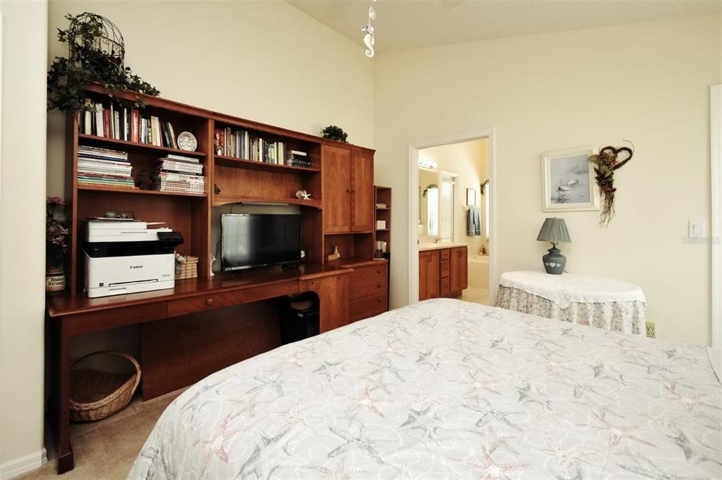 2591 Oneida Loop Kissimmee, FL 34747 - Photo 28 of 48 a bedroom with a bed and a flat screen tv