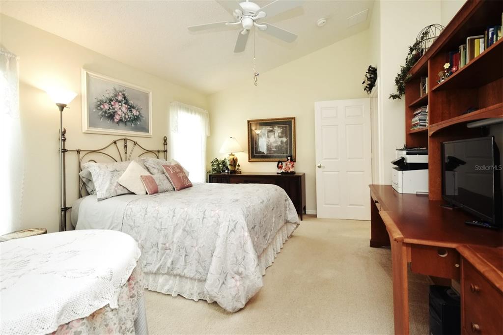 2591 Oneida Loop Kissimmee, FL 34747 - Photo 29 of 48 a bedroom with a bed and a flat screen tv