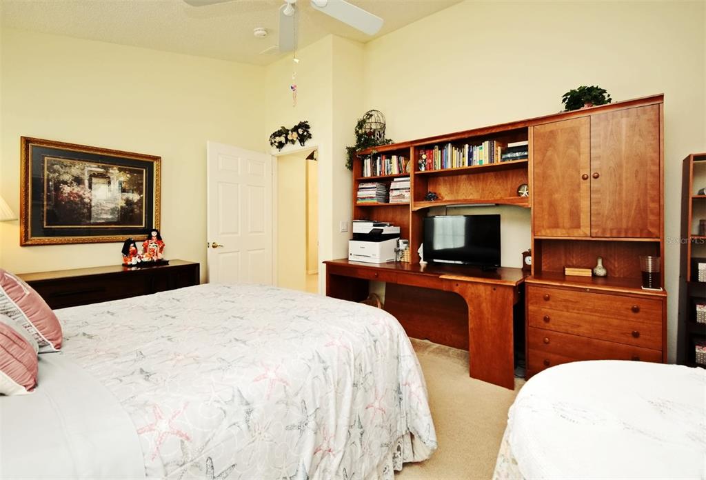 2591 Oneida Loop Kissimmee, FL 34747 - Photo 30 of 48 a bedroom with a bed and a flat screen tv