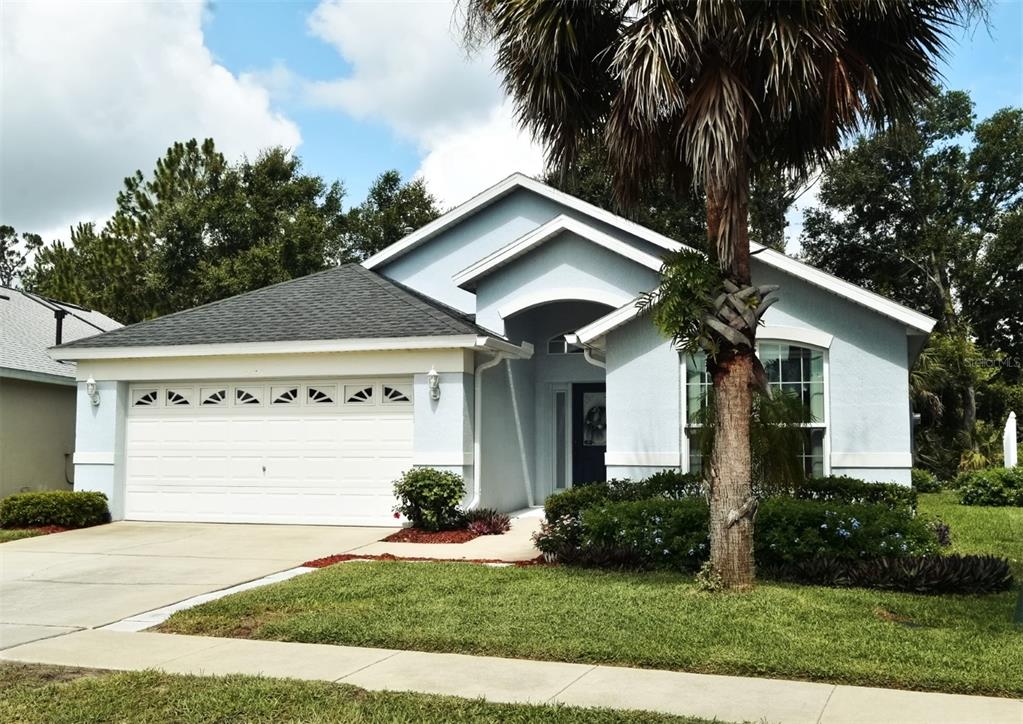 2591 Oneida Loop Kissimmee, FL 34747 - Photo 3 of 48 a front view of a house with a yard and garage