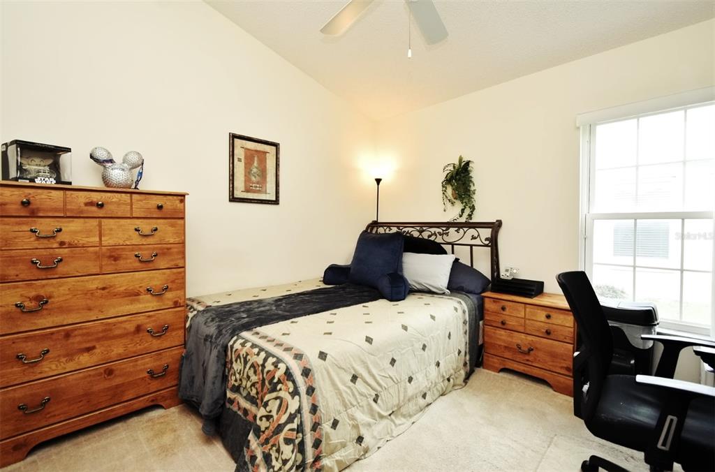 2591 Oneida Loop Kissimmee, FL 34747 - Photo 34 of 48 a bedroom with a bed and wooden floor