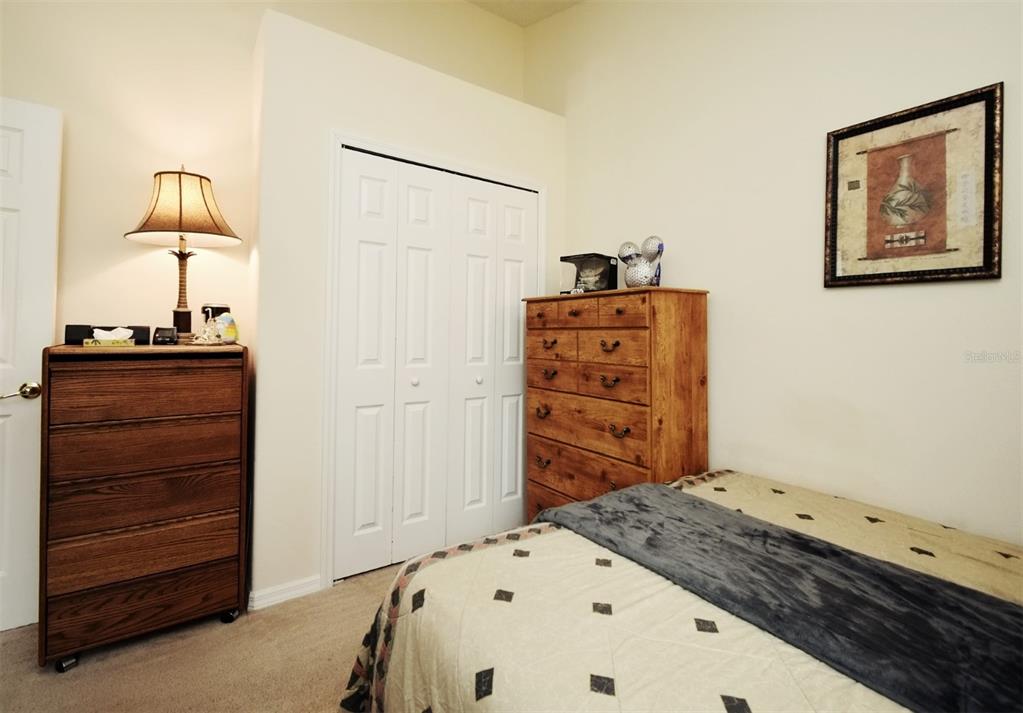 2591 Oneida Loop Kissimmee, FL 34747 - Photo 35 of 48 a bedroom with a bed and a dresser