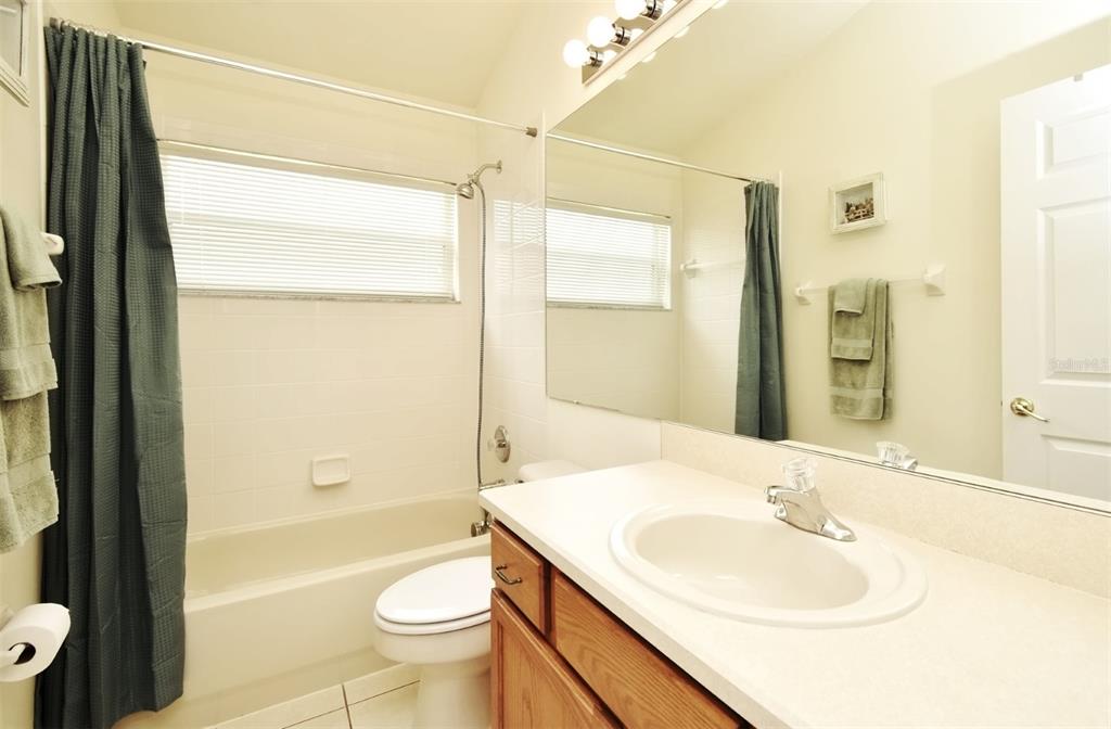2591 Oneida Loop Kissimmee, FL 34747 - Photo 36 of 48 a bathroom with a sink a toilet and shower