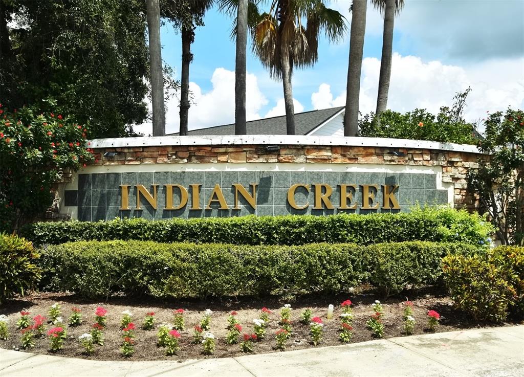 2591 Oneida Loop Kissimmee, FL 34747 - Photo 47 of 48 a front view of multi story residential apartment building with yard and sign board