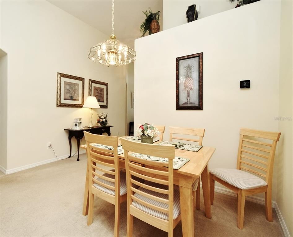 2591 Oneida Loop Kissimmee, FL 34747 - Photo 6 of 48 a view of a dining room with furniture and chandelier