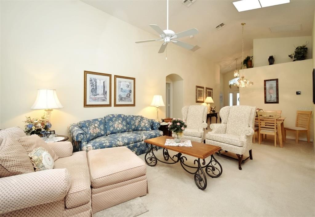 2591 Oneida Loop Kissimmee, FL 34747 - Photo 10 of 48 a living room with furniture and a chandelier