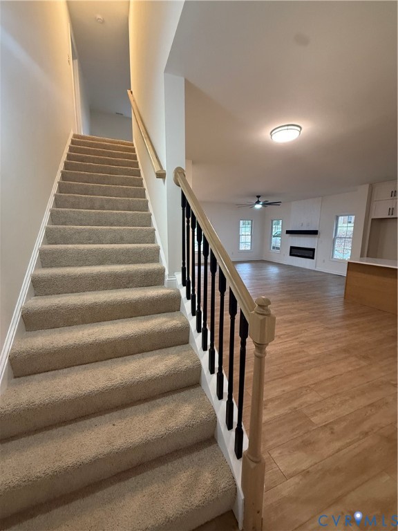 2700 Lake Albemarle Road Charlottesville, VA 22901 - Photo 16 of 25 Stairs featuring a fireplace, wood finished floors
