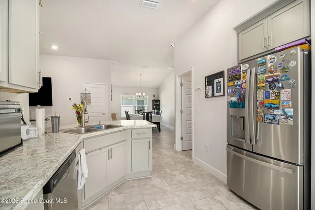 a kitchen with stainless steel appliances granite countertop a refrigerator and a sink
