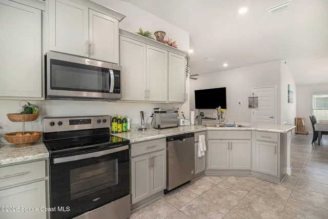a kitchen with stainless steel appliances a stove sink microwave and cabinets