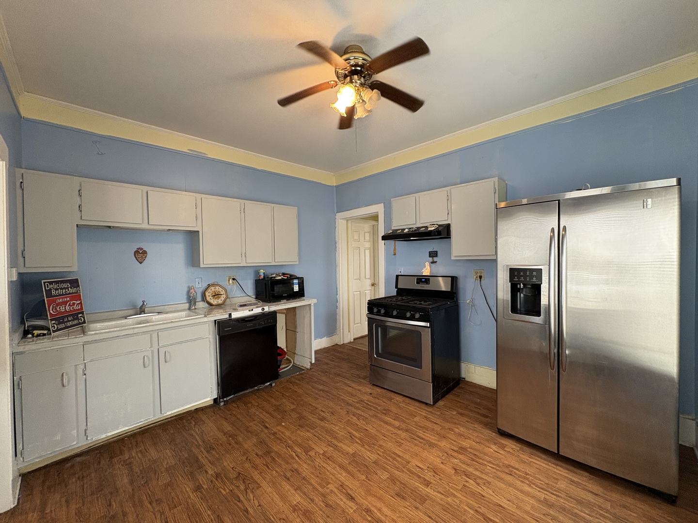 710 Mulberry Street Ottawa, IL 61350 - Photo 5 of 15 a kitchen with stainless steel appliances a sink cabinets and wooden floor