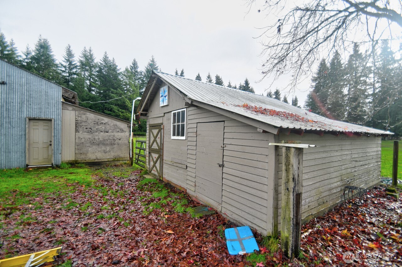 19944 Carper Road Southwest Rochester, WA 98579 - Photo 17 of 27 a view of a house with a yard and garage