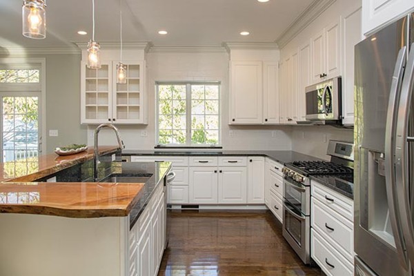 85 Pond Brook Road Newton, MA 02467 - Photo 4 of 6 a kitchen with stainless steel appliances granite countertop a sink stove and refrigerator