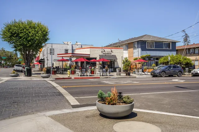 a terrace with outdoor seating and wooden floor