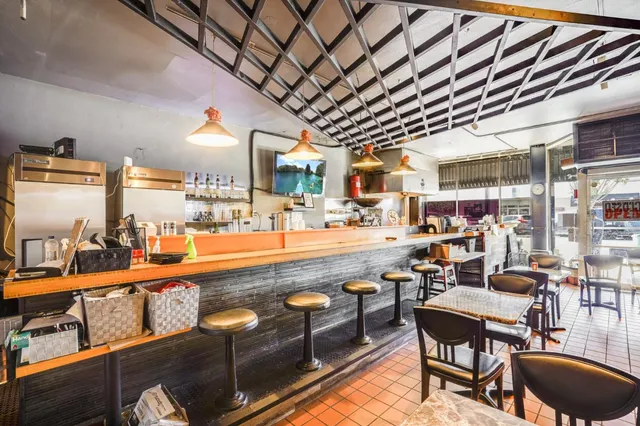 a blue bench sitting in front of a building